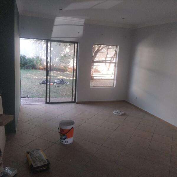 Apartment Interior Repaint & Kitchen Splashback - Living area prepped, with paint and materials on site