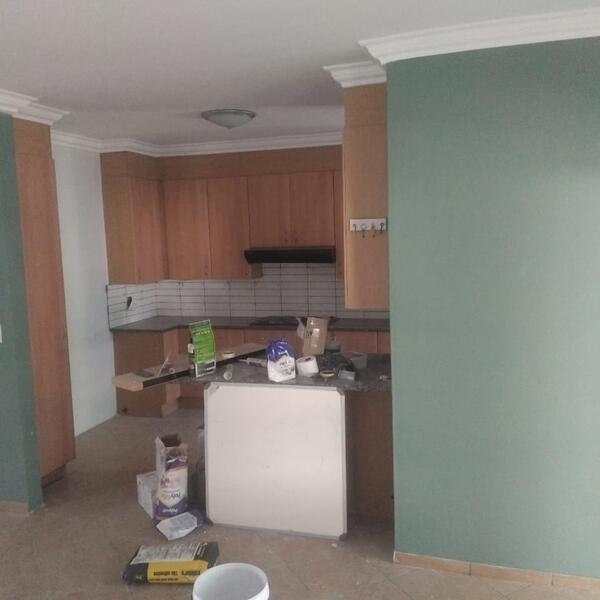 Apartment Interior Repaint & Kitchen Splashback - Kitchen and open-plan area mid-repaint
