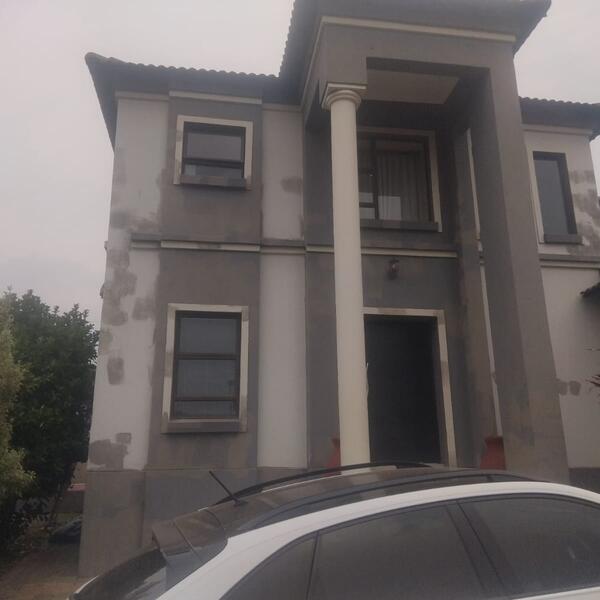 Double-Storey Exterior Restoration - Front façade patched and ready for paint