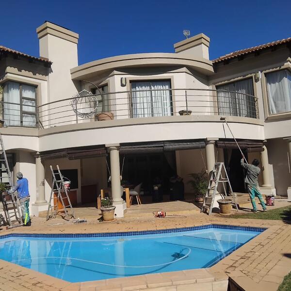 Family Home & Boundary Wall Repaint - Team painting the upper balcony by the pool