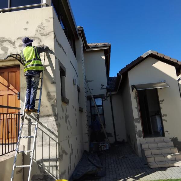 Modern Home Exterior Makeover - Patching cracks along the side of the house