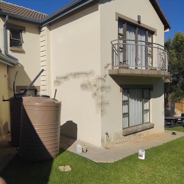 Modern Home Exterior Makeover - Balcony wall patched and ready for primer