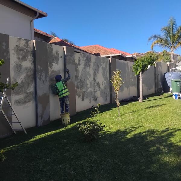 Modern Home Exterior Makeover - Boundary wall repairs underway