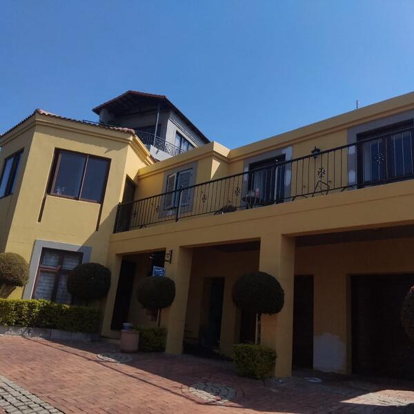 Townhouse Complex Exterior - Courtyard view of the balconies and garages